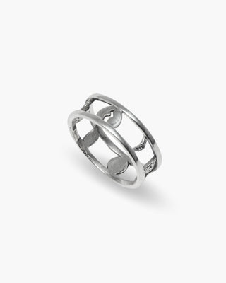 Protector ring in 925 sterling silver, open band with moon cutouts, angled view