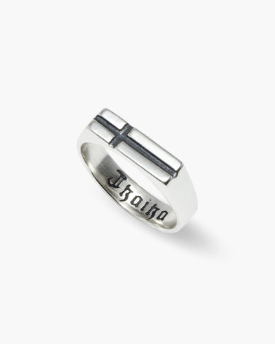 Cross the World ring in 925 sterling silver, flat cross signet with Old English lettering inside, angled view