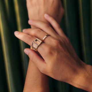 Island Time ring worn: hands crossed in front of palm leaves, wearing rings