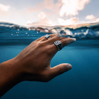 Island Time ring worn: hand reaching out of the ocean wearing a signet ring