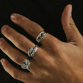Sad Boi ring worn: hand wearing three silver rings