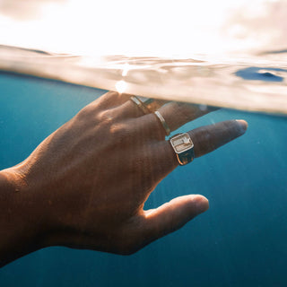 Sunny Boy ring worn: hand reaching out of the ocean wearing rings