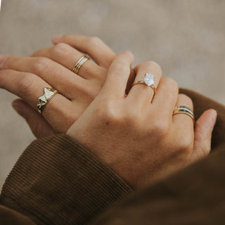 Mt. Ikaika ring worn: hands wearing stacked rings including a mountain ring