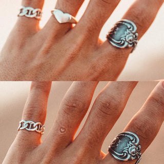 Feeling the Love ring worn: close-up of hands wearing silver rings including a heart signet and a chain ring