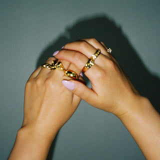 Round Your City Round the Clock ring worn: hands wearing stacked gold rings