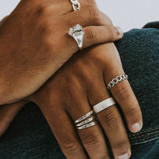 This Is Your Life ring worn: hands wearing silver rings against a denim jacket